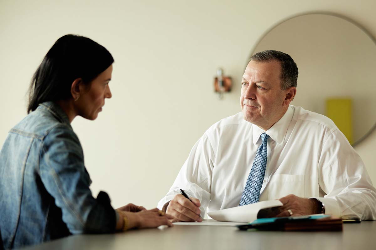 a bus accident lawyer in Austin meeting with a client