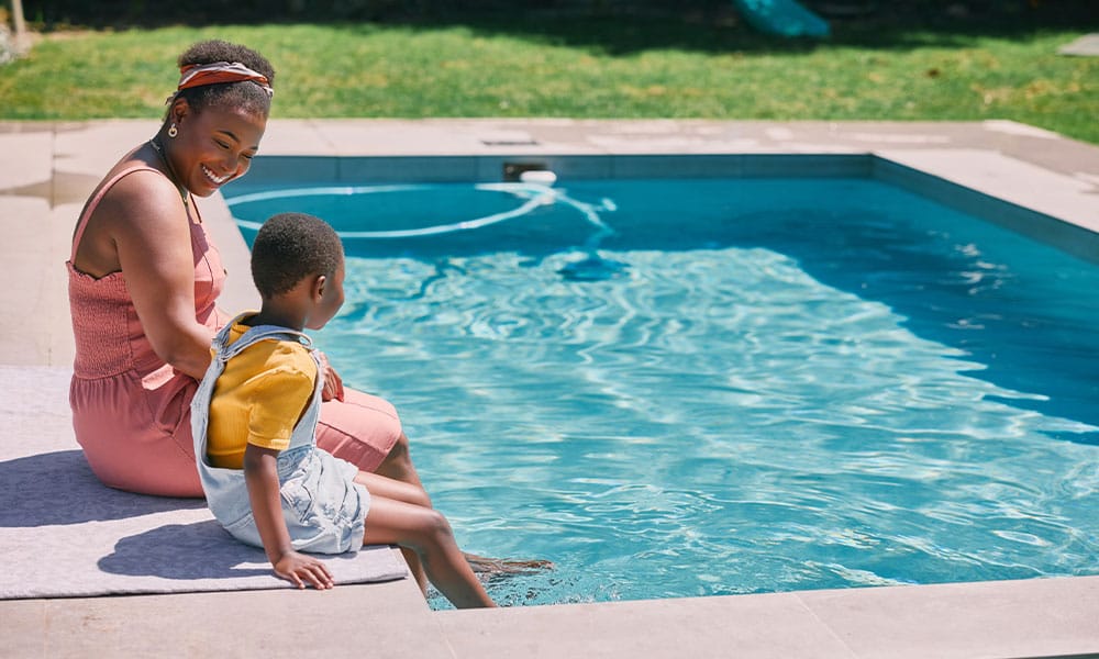 woman watching her child at her pool in Austin to prevent a swimming pool accident
